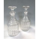 A pair of 19th century cut glass decanters and stoppers, with straight fluted sides and stepped