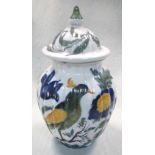 A French faience vase and cover, the lobed ovoid body painted with a fanciful bird perched amongst