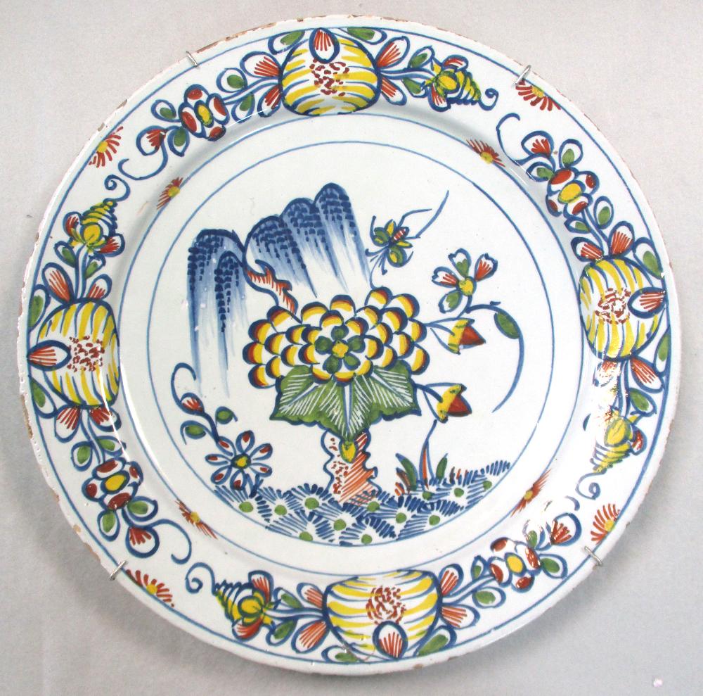 An 18th century Delft plate, decorated to the centre with a lady holding a cornucopia, within a - Image 3 of 7