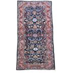 A Sarouk rug, 298 x 133cm (116 x 52in) Strong colours with good levels of pile