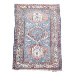 A Shirvan rug, 196 x 127cm (76 x 50in) Low pile, small holes and with losses to one end border