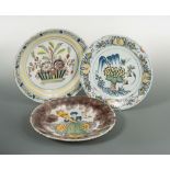 An 18th century Delft plate, decorated to the centre with a lady holding a cornucopia, within a