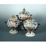 Three Mason's melon shaped two handled tureens and covers, circa 1815 - 1820, each decorated in