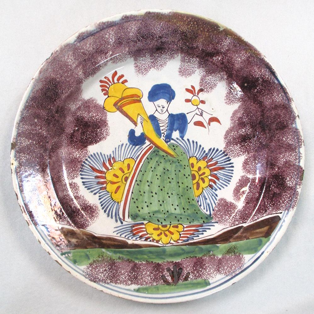 An 18th century Delft plate, decorated to the centre with a lady holding a cornucopia, within a - Image 7 of 7