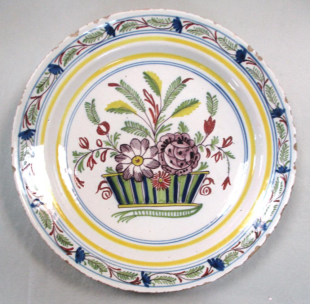 An 18th century Delft plate, decorated to the centre with a lady holding a cornucopia, within a - Image 5 of 7