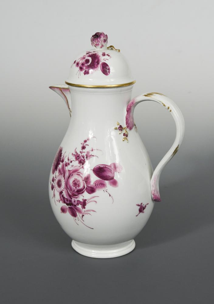 An 18th century Meissen coffee pot and cover, painted in puce camaieu with floral bouquets, gilt