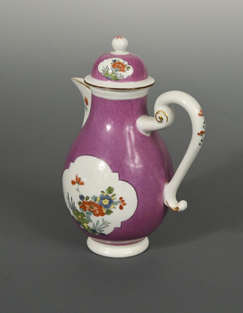 An 18th century Meissen purple ground milk jug and cover, circa 1740, the body reserved with two