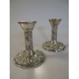 A pair of filled silver dwarf candlesticks