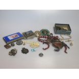 A collection of jewellery and coins and a gold watch