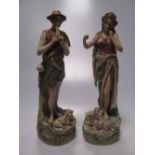 A pair of Royal Dux figures of a boy and girl, with a ram and a sheep by their sides 31cm high