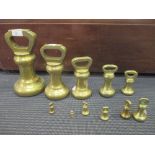 A graduated set of Avery brass bell weights largest 22cm high