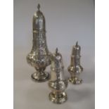 A pair of Victorian silver casters London 1897, and a large Victorian silver caster, Chester 1897,