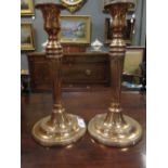 A pair of late 18th century bell metal neo-classical candlesticks (2)