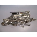 A collection of assorted silver flatware, some knives and a meat holder 40ozt weighable