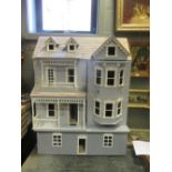 A large dolls house, modelled as a three storey Edwardian villa, fitted with electricity and