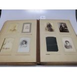 Two late Victorian leather photograph albums with mainly family portraits, and a Victorian family