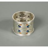 Liberty & Co., a silver and enamel napkin ring, Birmingham 1903, of circular form with ribbed