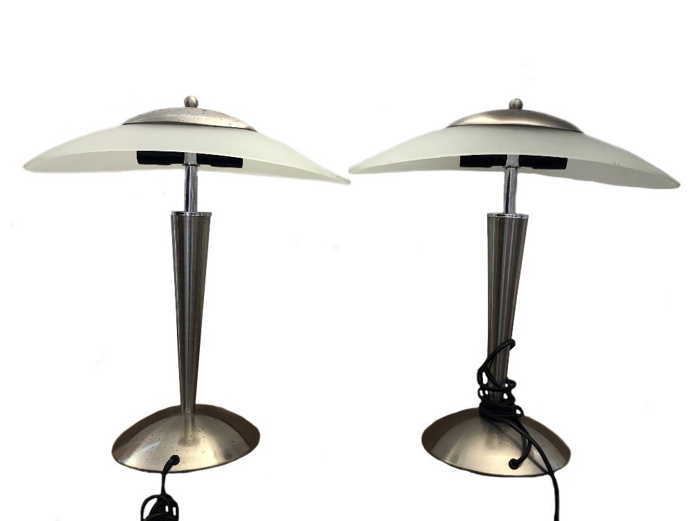 A pair of modern brushed steel and frosted glass table lamps, with oval shades and twin bulb