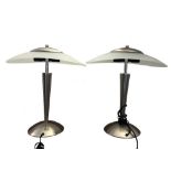 A pair of modern brushed steel and frosted glass table lamps, with oval shades and twin bulb