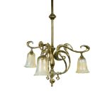 An Art Nouveau brass ceiling light with vaseline glass shades, the brass hanging rod supporting