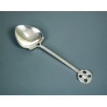 An Arts & Crafts silver spoon by A. E. Jones, Birmingham 1908, the rounded triangular bowl with
