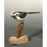§ Guy Taplin, (British, born 1939), Long Tailed Tit, polychrome painted wood, metal and driftwood,
