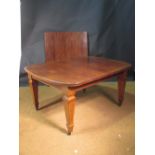 A late Victorian mahogany extending dining table with three leaves on tapering square legs crossban