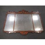 A George III style triple wall mirror with carved cresting and centred with Prince of Wales