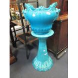 A Minton majolica turquoise glazed jardiniere on stand (stand A/F)