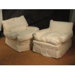 A pair of Duresta easy armchairs with low square backs and loose cushion seats, one back cushion