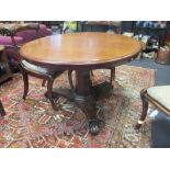 A Victorian mahogany pedestal breakfast table with tilt-top, on an octagonal tapering column and