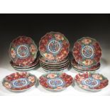 Fifteen Japanese circular shaped plates decorated in the Imari palette, with faux Chinese Chenghua