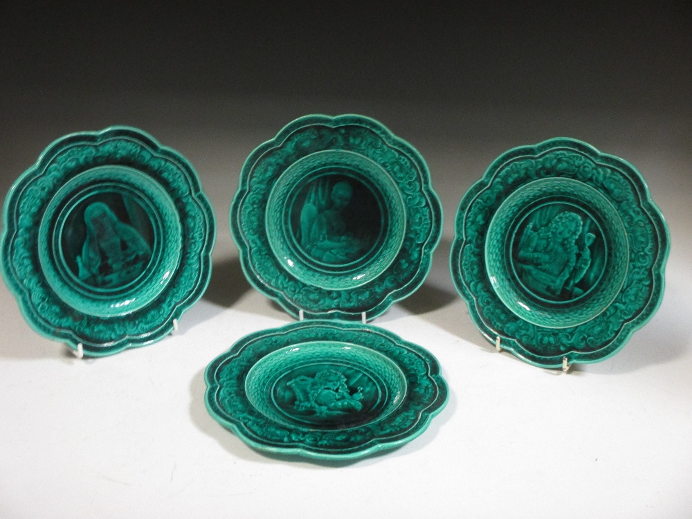 A set of four green ground majolica plates by Rubelles