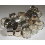 A collection of twelve napkin rings of silver and silver plate (11)