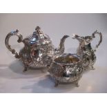 A Victorian harlequin repousse three piece silver tea set, Victorian and later (3)