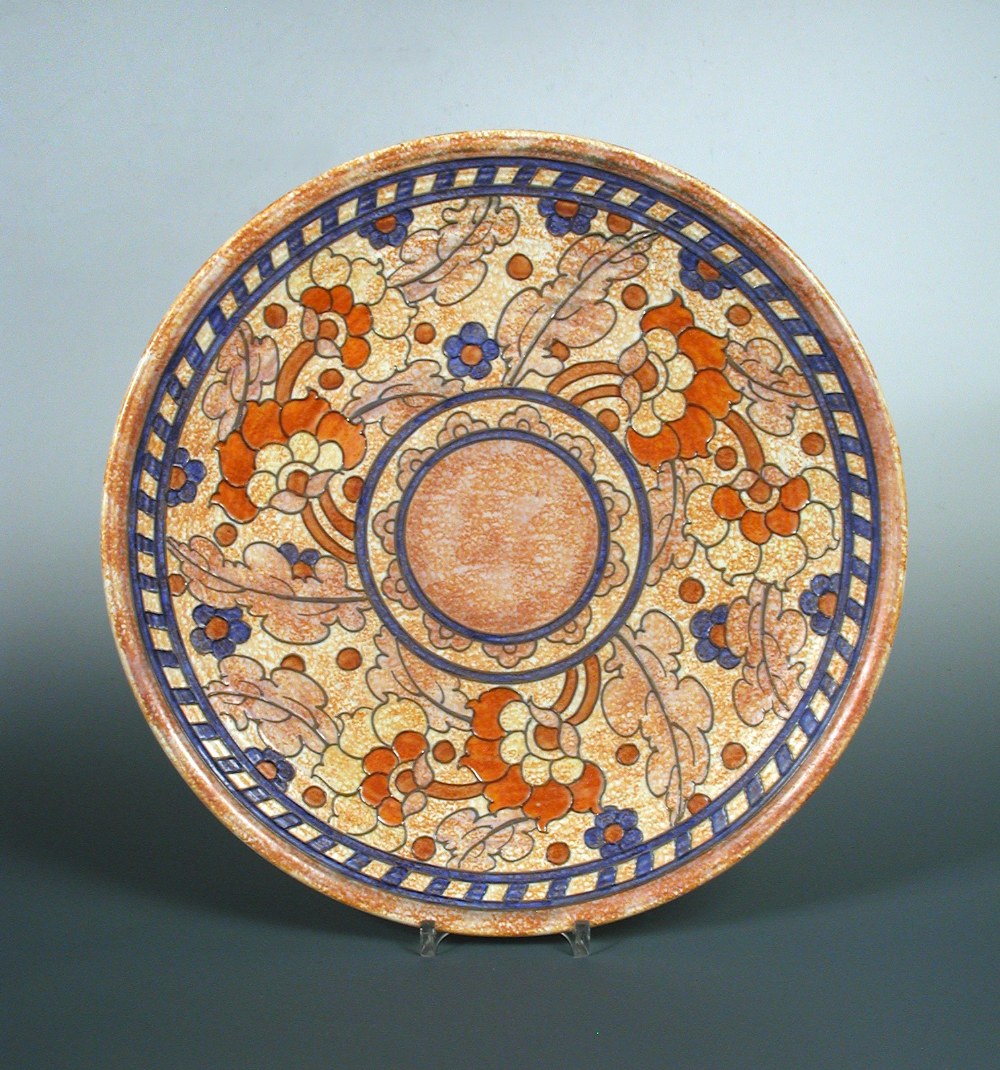 A Charlotte Rhead charger, with tubelined foliate decoration, printed and painted marks, 36cm wide