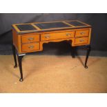 A Continental satinwood writing desk, with black tooled leather writing surface, on ebonised legs,