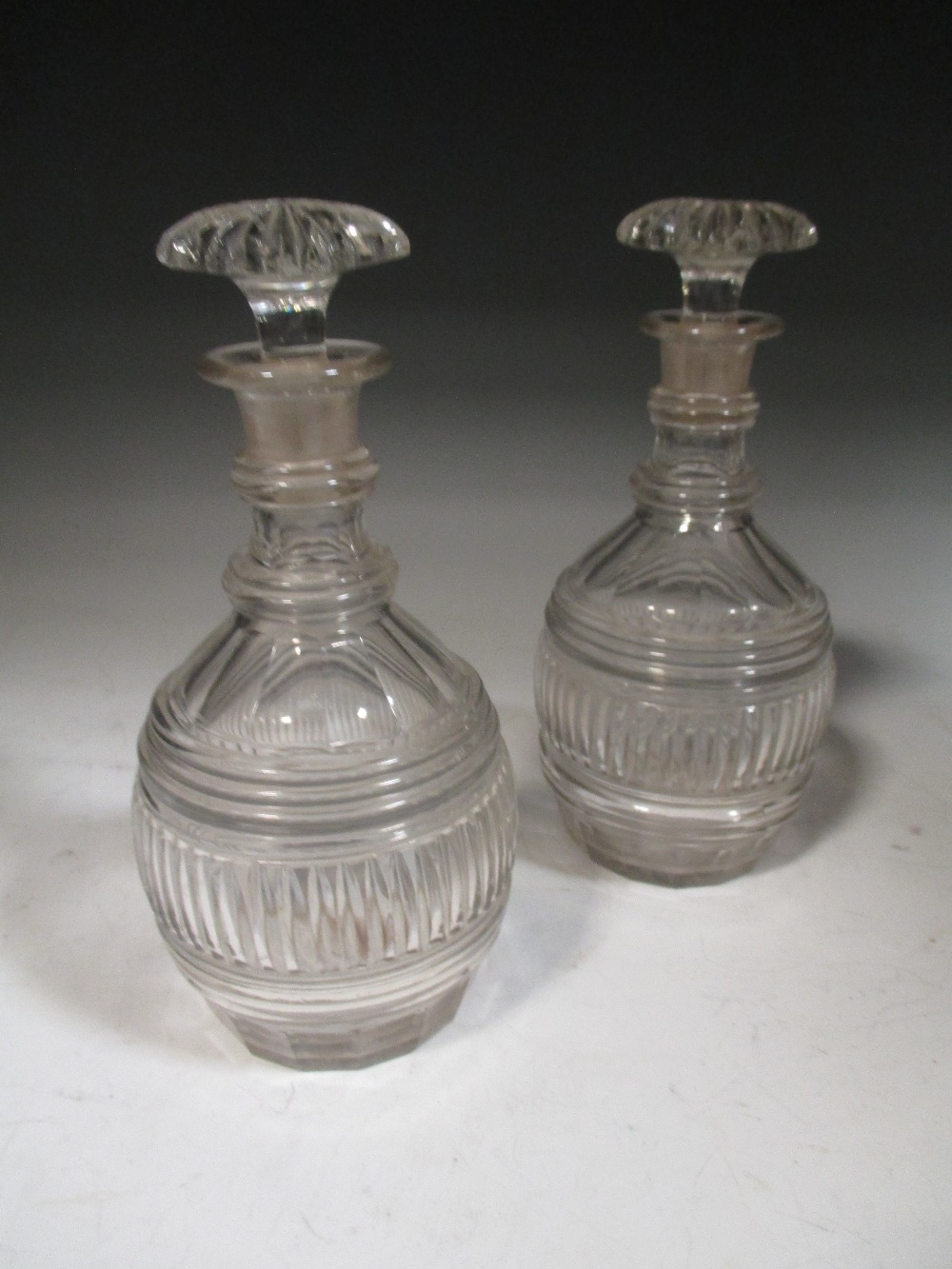 A pair of small Regency cut glass decanters with mushroom stoppers (2)