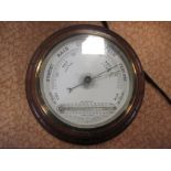 An Edwardian mahogany and brass mounted aneroid barometer with thermometer
