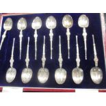 A cased set of 12 silver coffee spoons, a pair of cased silver fruit spoons, a pair of silver