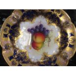 A Royal Worcester cabinet dish painted with fruit by A. Shuck, signed, 24cm diameter; and a Derby