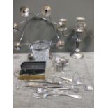 A collection of silver plated ware including two candelabra, flatware, game skewer, marrow scoop,