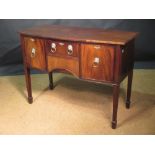 A small Regency style mahogany bow front sideboard with brass lion mask and ring handles, on