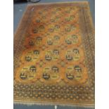 A Bokhara cinamon ground rug of traditional design 298cm x 201cm