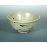 A St Ives pottery bowl, the flared bowl with iron and cobalt oxide glaze raised on an unglazed foot,