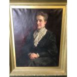 Late 19th Century English School, formal portrait of a lady, with folded hands, in a black dress,