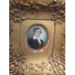 Two early 19th century portrait miniatures of young gentlemen, in a rosewood frame and a gilt