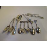 A pair of silver gilt berry spoons, three butter knives, a fruit spoon, mustard spoon and five