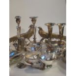 A collection of silver plated items including a pair of pheasants, a pair of candlesticks, vases,