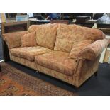 A pair of Duresta two seater sofas with loose seat cushions and on turned legs and casters, 238cm